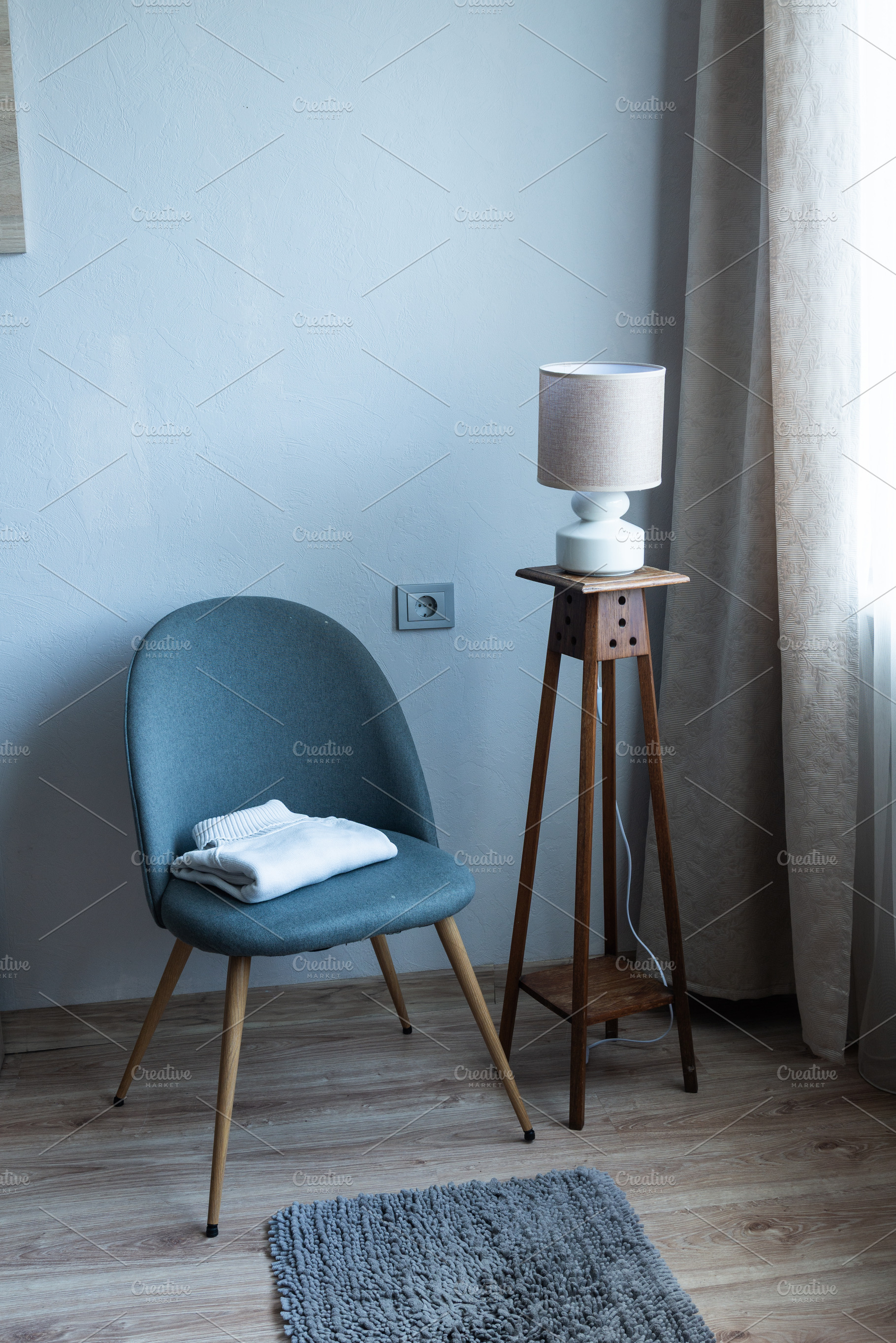 Cozy armchair with folded blanket in modern minimalist living ro, an Industrial Photo by MDBildes