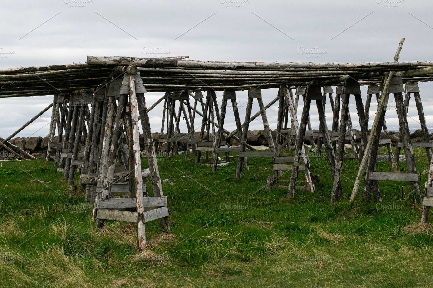 Traditional wooden drying racks on a landscape near Akranes, Iceland, a Photo by AS photostudio