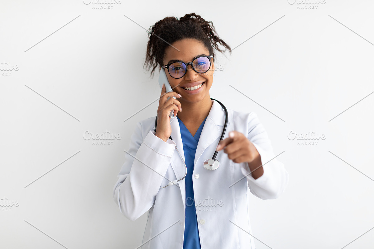 Portrait of black doctor smiling and posing to camera, a Photo by Prostock-Studio (Photo 2 of 2)
