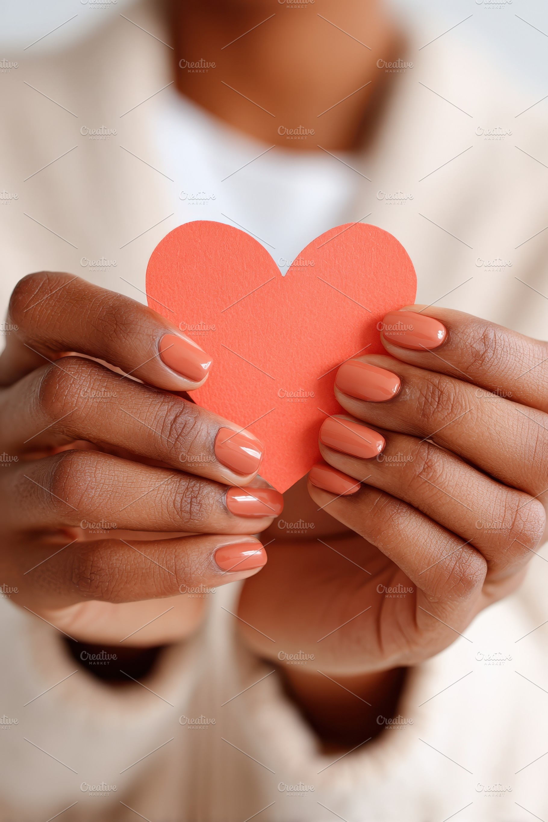 Hands holding a red heart cutout, a Holiday Photo by AlyaAnd