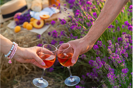 Wine in glasses is held by a woman, a Person Photo by yanadjana