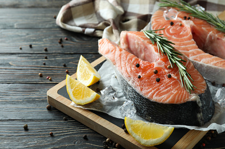Concept of cooking salmon on wooden table, a Food & Drink Photo by AtlasStudio PRO