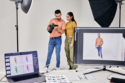 Collaboration, photographer and startup people in studio set with camera for shoot, magazine project or online content. Planning or teamwork examine picture for digital catalog or fashion web design, a Photo by Peopleimages.com