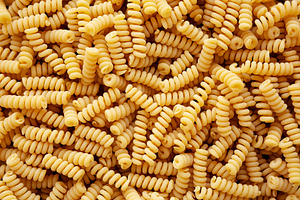 Uncooked Organic Dry Fusilli Pasta, top view. Flat lay, overhead, a Food & Drink Photo by LiudmylaChuhunova