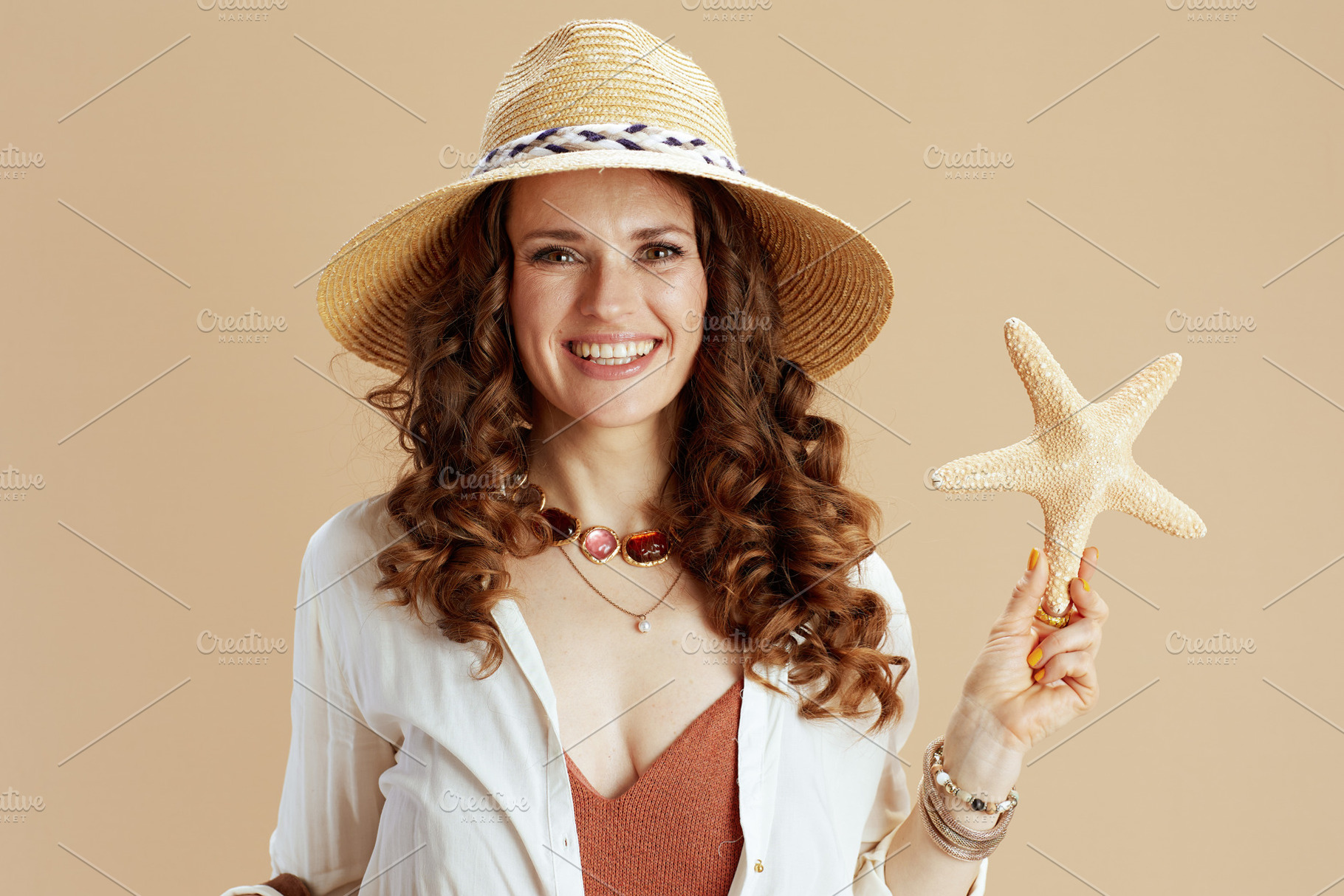 smiling elegant woman in blouse and shorts on beige, a Person Photo by Alliance Images