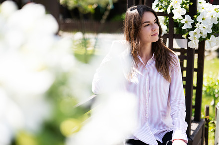 Young beautiful brunette woman in shirt sit on wooden bench with, a Person Photo by AS photostudio