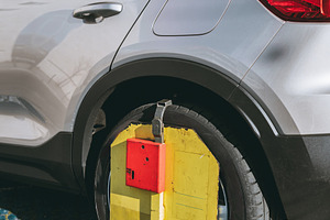 Car wheel immobilized, clamp device, a Transportation Photo by SkyNext