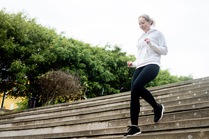 Active woman running up outdoor stairs during fitness workout, a Sports & Recreation Photo by etorres69