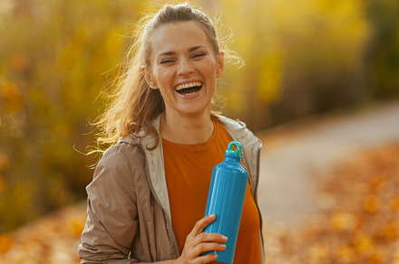 smiling fit 40 years old woman in fitness clothes in park, a Person Photo by Alliance Images