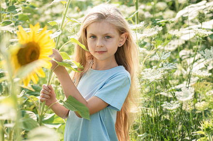 Beautiful little girl in sunflowers, a Person Photo by Olena Rudo
