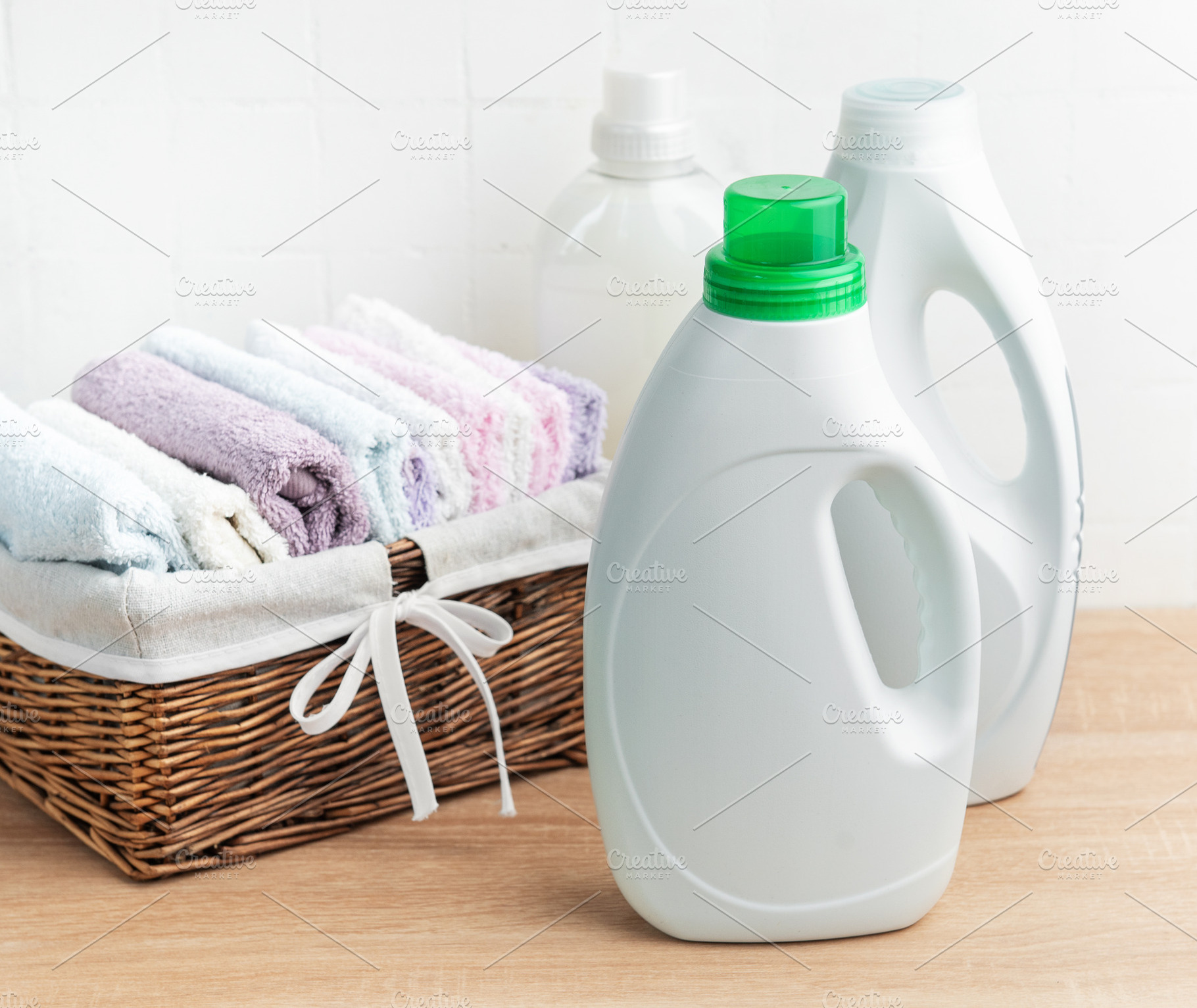 Laundry detergent bottles and clean folded towels, an Industrial Photo by Olena Rudo