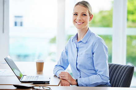 Smiling, happy and proud business woman, entrepreneur and leader working on a laptop in an office. Portrait of a caucasian accounts executive, hr manager and administrator in a corporate agency, a Photo by Peopleimages.com