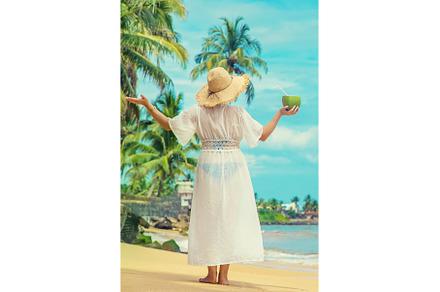 Girl on the beach drinks coconut, a Person Photo by yanadjana