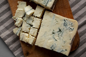 Blue cheese Gorgonzola on a Wooden Board, top view. Close-up., a Food & Drink Photo by LiudmylaChuhunova