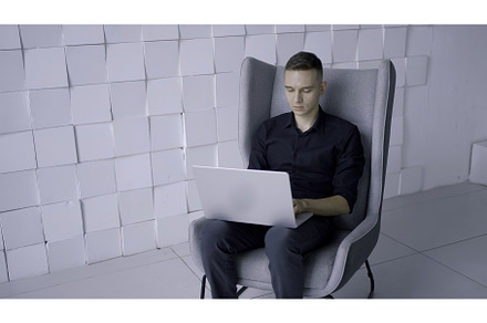 Young man sitting in modern, a Technology Photo by Media Whale Stock