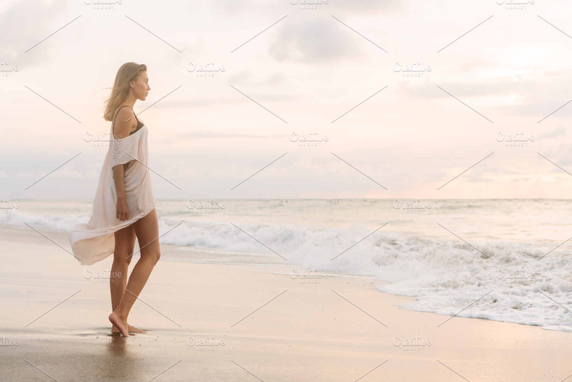 Young beautiful girl at the seaside stock photo containing sea and vacation, a Person Photo by Mikalai