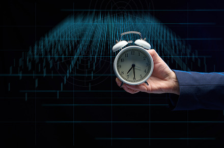 hand of a businessman holds a round alarm clock on the backgroun, a Business Photo by ndanko