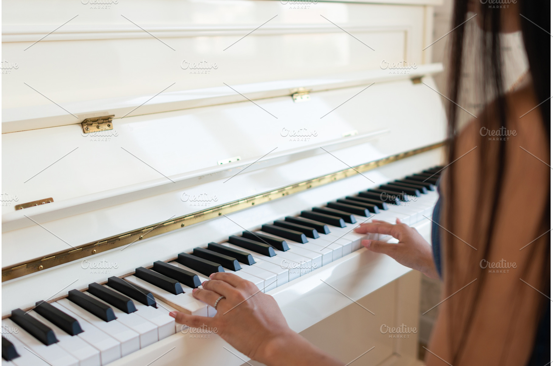 A woman plays the piano, a School & Education Photo by undrey