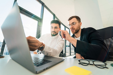 Two businessmen are working, a Photo by borodai94