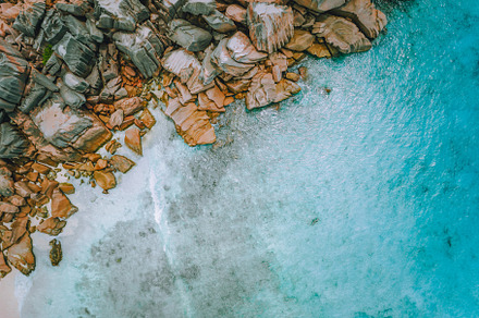Top aerial drone view tropical blue containing beach, aerial, and sea, a Nature Photo by Igor Tichonow