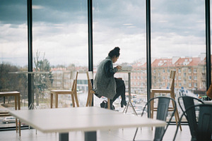 A girl working with a city view