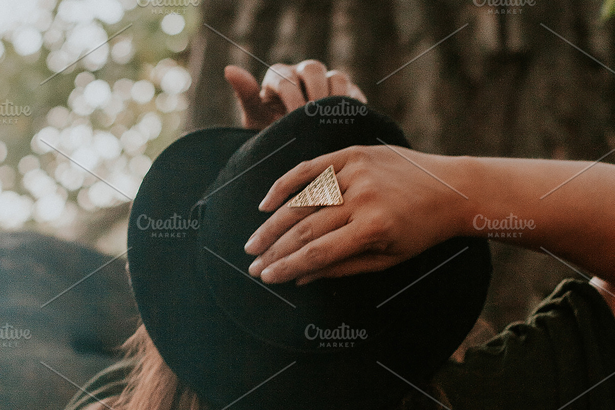 Woman with hands on her hat, a Person Photo by Wild Wander Collective (Photo 1 of 2)