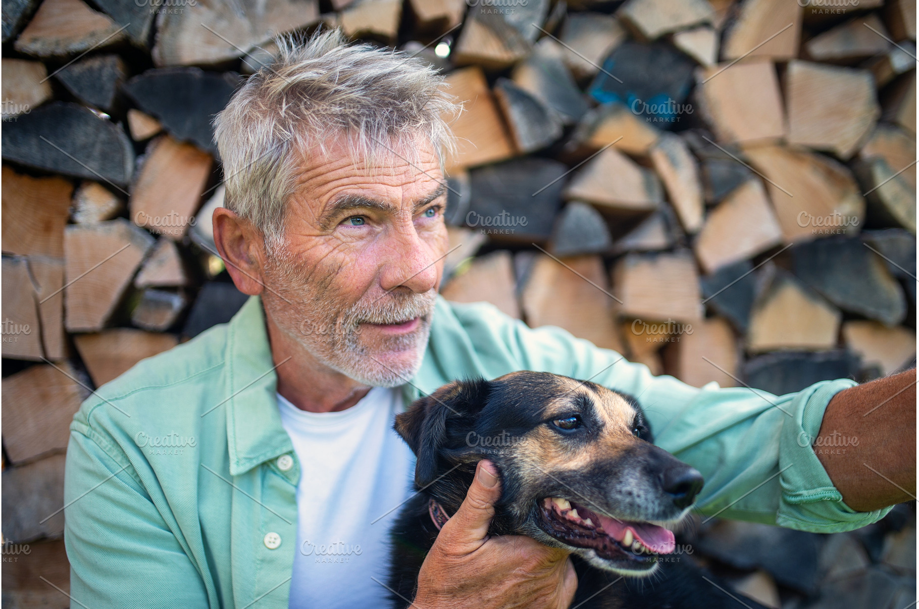Older man with dog in front of, an Animal Photo by HalfPoint