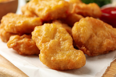 Fried chicken nuggets on wooden board, close up, a Food & Drink Photo by AtlasStudio PRO