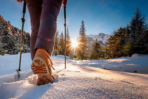 Legs of mountaineer walking through the snow at dawn., a Sports & Recreation Photo by Davizro's Market