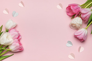 Pink and white tulips forming a border with paper hearts on a pi, a Holiday Photo by Olena Rudo