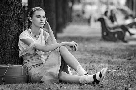 Girl lies on a grass in fashionable clothes stockings a sundress stock photo, a Person Photo by Serovphoto