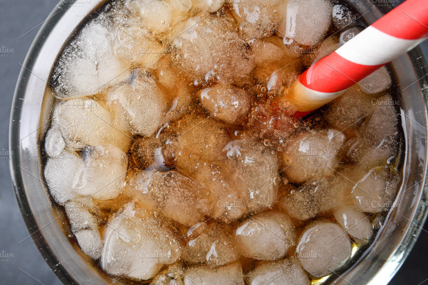 Detail of glass with refreshing drink with ice top view, a Food & Drink Photo by Davizro's Market