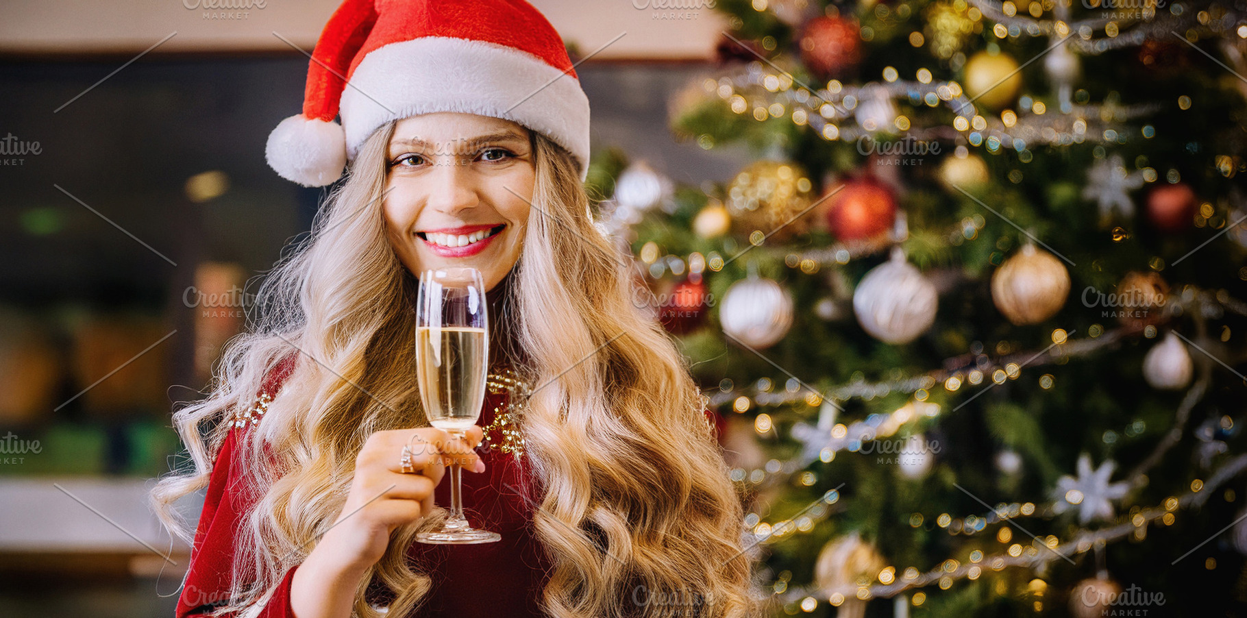 Smiling girl with Santa hat celebrating Christmas at home, a Holiday Photo by Davizro's Market