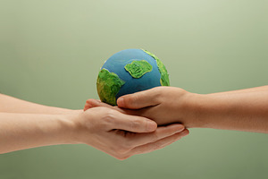 Two people holding Globe together. Environmental awareness, sust, a Photo by salmon.black