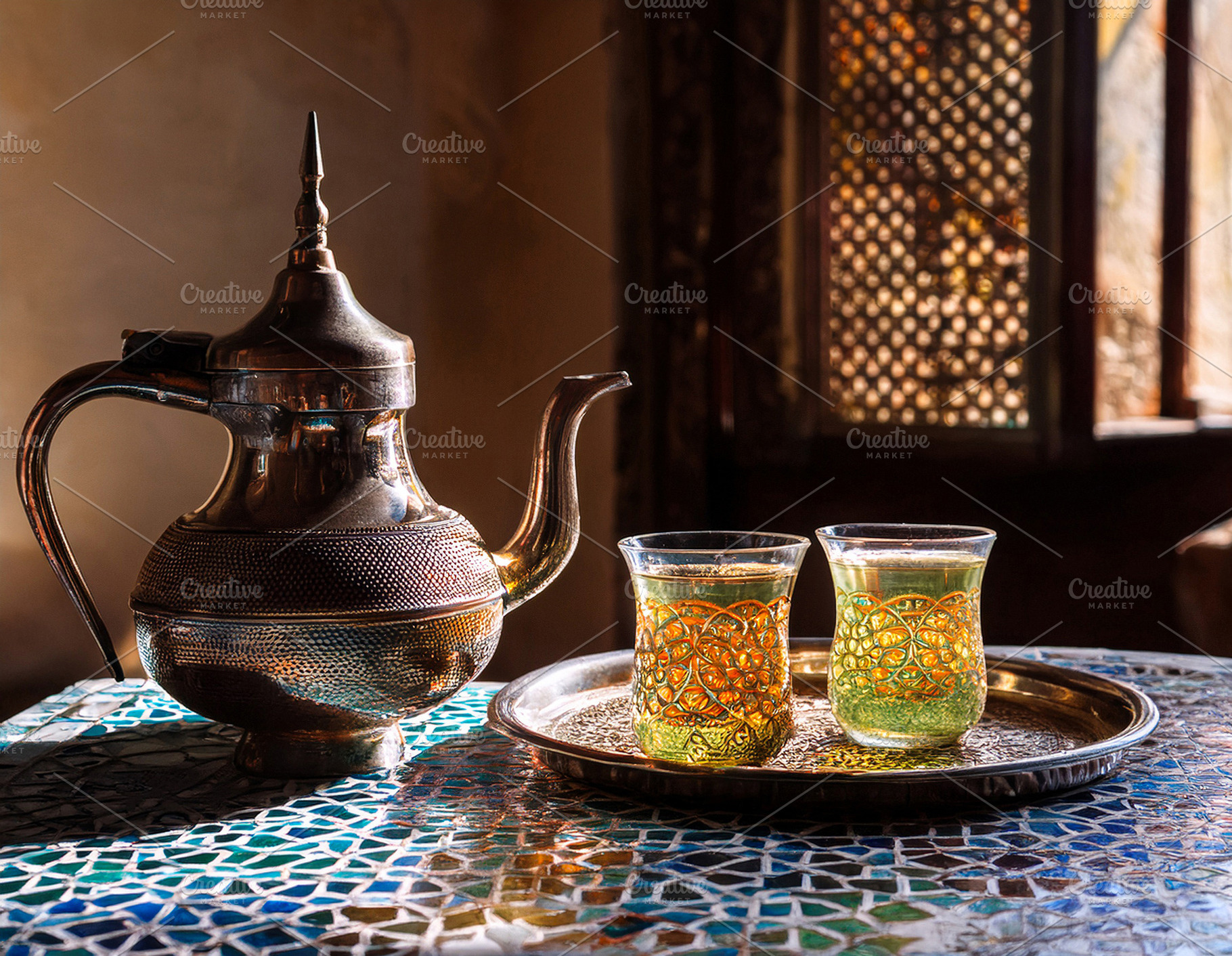 Moroccan tea on ceramic mosaic table in a room, a Food & Drink Photo by Davizro's Market