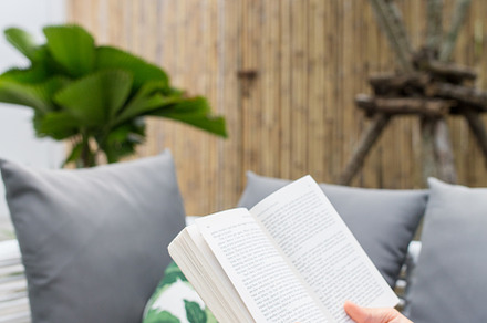 A woman holding a reading a novel