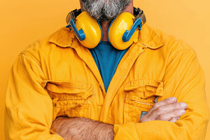 Confident man in yellow jacket with headphones, a Person Photo by AlyaAnd
