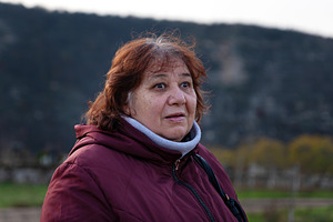 Portrait of a senior woman in a burgundy jacket with an expressi, a Person Photo by Ales Munt