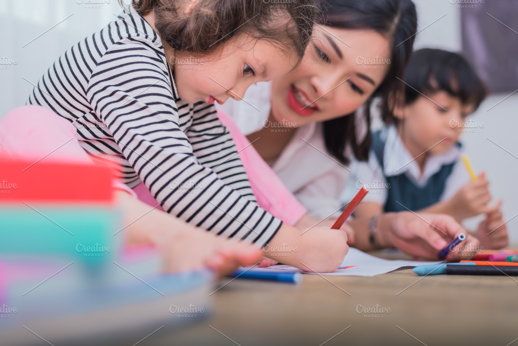 Cute kids and Asian teacher drawing in artist class. Back to sch, a Person Photo by Ministocker
