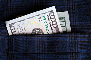 Closeup of a $100 US dollar bill tucked into a blue plaid suit pocket, symboliz, a Business Photo by Ales Munt