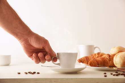 Hand taking hot morning coffee on breakfast table with croissant, a Food & Drink Photo by Davizro's Market