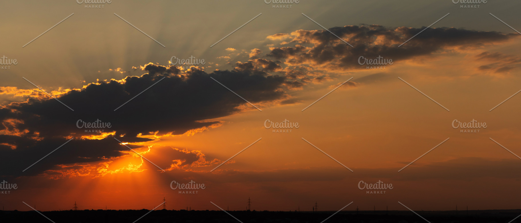 Orange sunset with sun rays shining, a Wallpaper Photo by Elena Vagengeim