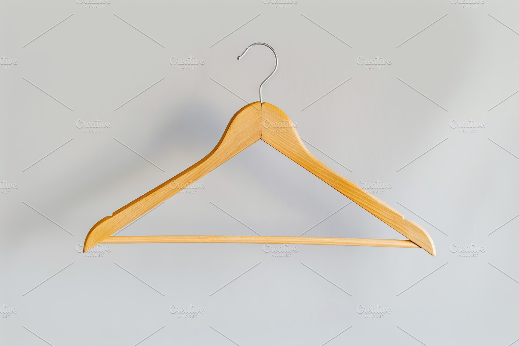 Wooden hanger on white background, an Abstract Photo by AlyaAnd