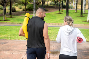 Friends walking with yoga mats in the park, a Sports & Recreation Photo by etorres69