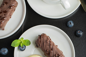 Delicious glazed curd snacks with fresh blueberries and mint on light grey tabl, a Food & Drink Photo by Budarinphoto