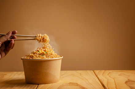 Bow of Hot Boiled Instant Noodles on the Table. Hand Using Chops, a Food & Drink Photo by salmon.black