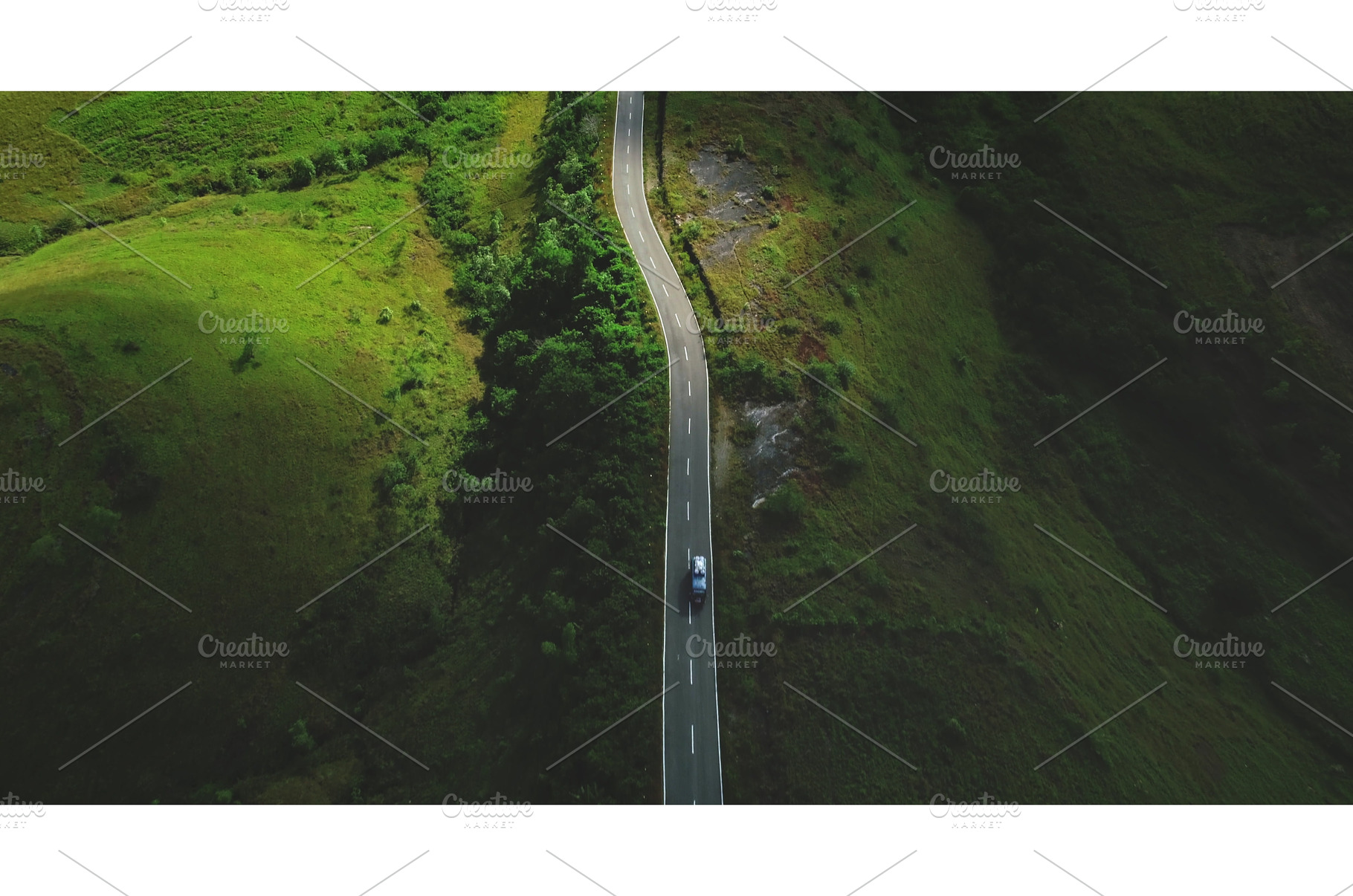 Car driving on winding road in Sumba, a Nature Photo by Goinyk