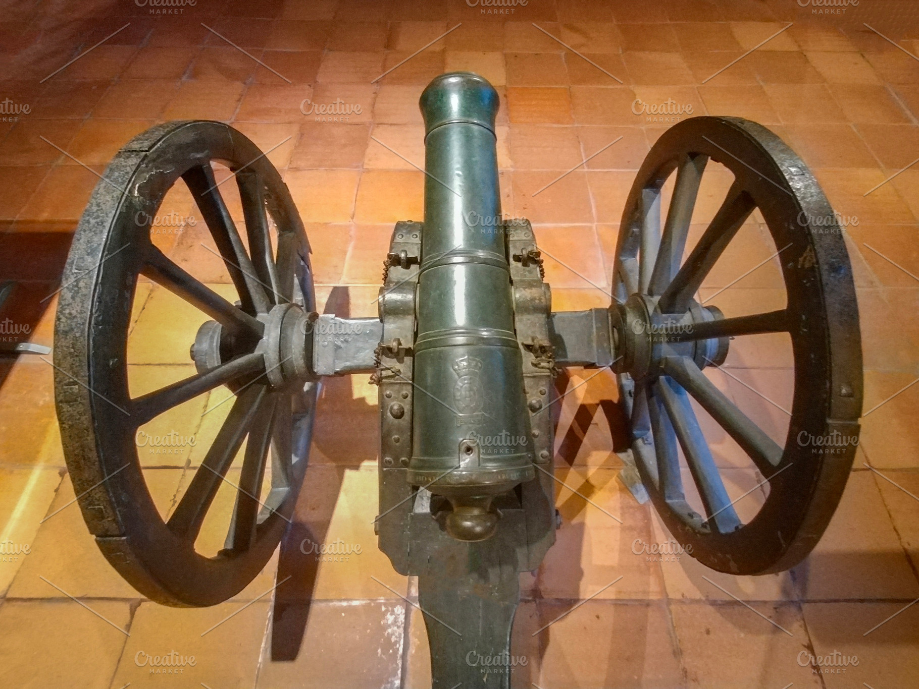 Old bronze cannon with wooden wheels indoors, an Arts & Entertainment Photo by DanFLCreativo