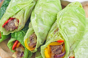 Healthy cabbage leaves wraps with beef, vegetables and cheese, served with plai, a Food & Drink Photo by iuliia_n