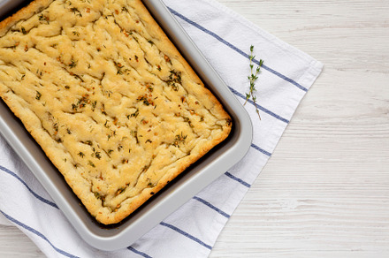 Home-baked Rosemary Garlic Focaccia Bread on baking tray, top vi, a Food & Drink Photo by LiudmylaChuhunova